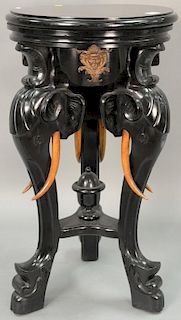 Ebonized table/pedestal with revolving top on carved elephant supports with faux tusks of wood. ht. 33in., dia. 18 1/2in.