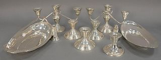 Group of sterling silver to include two oval trays, pair of weighted candelabras, four candlesticks, and a salt and pepper. h