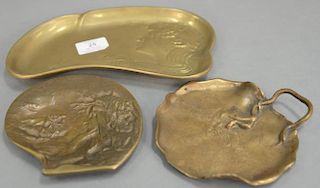 Three art nouveau bronze trays including French nude/dragonfly, bust of a girl watching a frog rowing a lily pad and a large