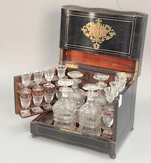 Brass inlaid ebony and rosewood tantalus set with four decanters and 16 stemmed glasses.