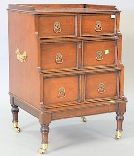 George IV style mahogany cabinet of three drawers on brass wheels. ht. 27in., wd. 18 1/2 in., dp. 17in.