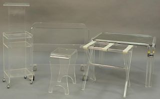 Six piece lucite/plexiglass group to include drying rack, two 3 tier stands, pedestal, stool, and mirror topped table.