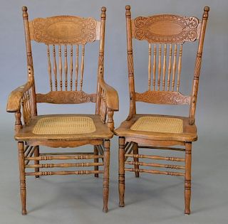 Set of seven oak pressed back chairs with caned seats including one armchair and six side chairs.