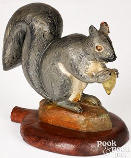 Carved and painted squirrel with nut