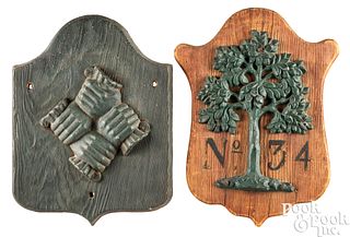 Two cast lead firemarks mounted to boards, 19th c.