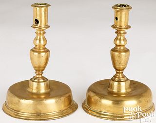 Two similar Spanish bell based brass candlesticks