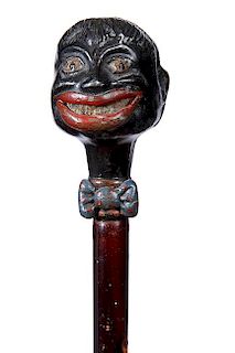 40. African-American Minstrel Cane- Ca. 1910- A cast metal handle of a gentleman in bow tie which retains most of its’ orig