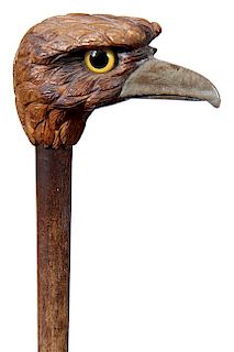 45. Folk Art Bird Cane- Ca. 1925- A carved large bird of prey with two color glass eyes, pyro decoration, painted beak, hardw