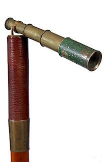61. Captain’s Telescope Cane- Ca. 1880- A unique and hard to find three draw brass 6 ½” telescope which is hinged and fo