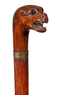 63. Gun and Dagger Cane- Ca. 1890- Carved hardwood handle in the form of a tiger with bone teeth and two color glass eyes, pu