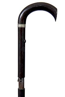 72. Remmington Gun Cane- Ca. 1885- A Remminton sliding shaft, 22 caliber working gun cane with a push button trigger on the u