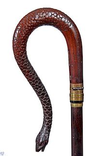79. Gun Snake Cane – Ca. 1880 – A foreign carved 15” snake handle with brass attachments and dropdown trigger which has