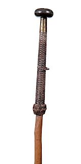 84. Makilla Weapon Cane- Dated 1936- A fine example with a horn handle and a signed brass collar, woven leather handle cover 