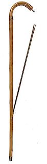 110. Saw Cane- Ca. 1880- An English gardener’s saw cane with brass and iron attachments, beech shaft and a metal ferrule. O
