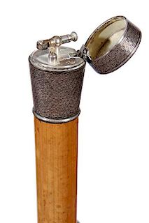 124. Cigar Lighter Cane- Early 20th Century- A machined silver British handle with a hinged top which contains an early cigar