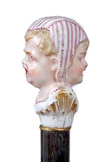 143. Porcelain Dress Cane- Ca. 1880- A hand painted porcelain handle with a woman frowning and on the other side she is smili