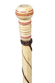 153. Nautical Whalebone Cane- Ca. 1870- A whale’s tooth turned handle with red paint decoration, small woven leather collar