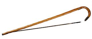 211. Saw Cane- Ca. 1880- An English gardener’s saw cane with brass and iron attachments, beech shaft and a metal ferrule .O