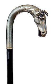228. Silver Horse Cane – Ca. 1930 – A well cast German silver horse with two colors glass eyes. Ebony shaft and a horn fe