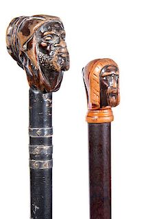 251. Two Blackamoor Dress Canes – Ca. 1920 – Both feature a carved bearded figure in head scarf and tassel, signed sterli