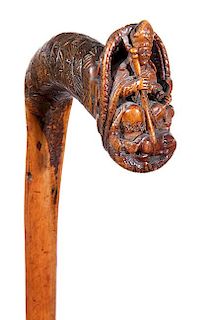255. Pope Folk-Art Cane – Ca. Late 19th Century – A high-relief carved root which has a pope figure in his hat holding hi