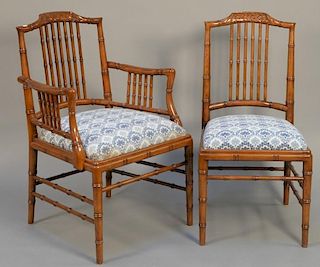 Set of twelve faux bamboo style dining chairs with blue and white needlepoint seats, two arm and ten sides.