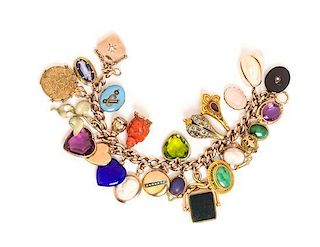 A Yellow Gold Charm Bracelet with 26 Attached Charms, 72.80 dwts.