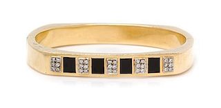 * A 14 Karat Yellow Gold, Onyx and Diamond Bangle Bracelet. 19.85 dwts.