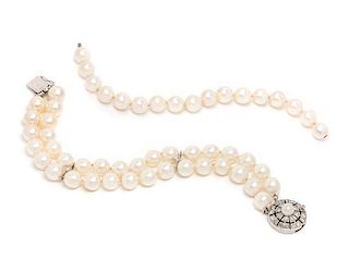 * A 14 Karat White Gold, Diamond and Cultured Pearl Double Strand Bracelet, 31.80 dwts.