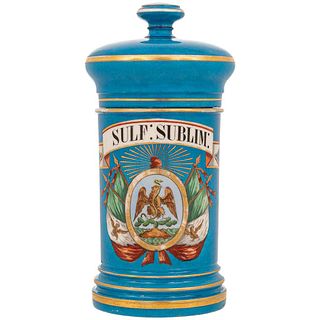 FRASCO DE BOTICA FRANCIA, CA. 1900. Elaborado en porcelana, color azul. Cartela con escudo nacional mexicano, gorro frigio y banderas.