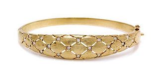 * A 14 Karat Yellow Gold and Diamond Bangle Bracelet, 14.35 dwts.