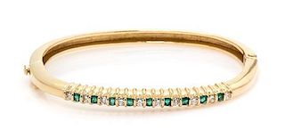 * A 14 Karat Yellow Gold, Diamond and Emerald Bangle Bracelet, 11.70 dwts.