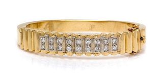 * A Yellow Gold and Diamond Bangle Bracelet, 22.65 dwts.