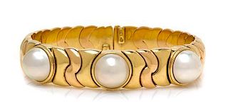 * An 18 Karat Bicolor Gold and Cultured Mabe Pearl Flexible Bangle Bracelet, Italian, 49.55 dwts.