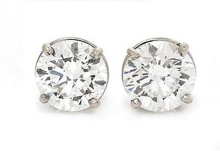 * A Pair of White Gold Diamond Stud Earrings, 0.90 dwts.