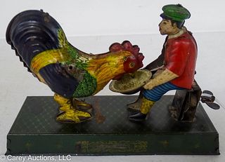 TIN WIND UP MAN FEEDING ROOSTER TOY