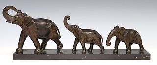PATINATED METAL SCULPTURE THREE MARCHING ELEPHANTS ON BLACK STONE BASE