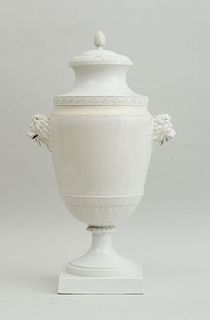 CONTINENTAL IVORY-GLAZED FAIENCE URN AND COVER