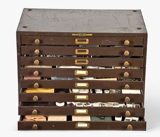 An eight drawer cabinet containing wrist and pocket watch movements parts and complete watches