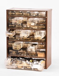 A thirty five drawer cabinet containing wrist and pocket watches cases and movements