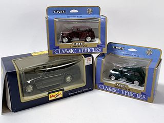 THREE DIE CAST CARS ERTL AND MAISTO IN BOXES