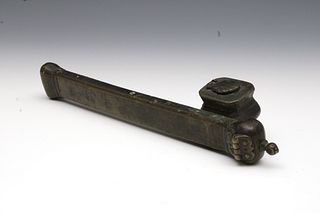 An Islamic Possibly Ottoman Brass Pen Case with an Ink Chamber from the 19th Century.

H: Approximately 5.5cm
L: Approximately 24.5cm 
