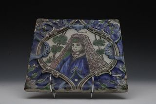 A Qajar Moulded Tile from the 19th Century Depicting an Armenian Woman.

H: Approximately 20.7cm
L: Approximately 21.3cm 