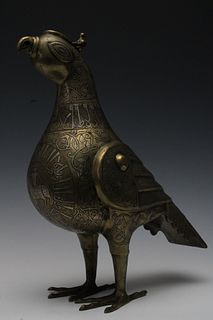 An Islamic Bronze Incense Burner in the Shape of a Bird with Silver Inlay and Islamic Calligraphy.

H: Approximately 34cm 