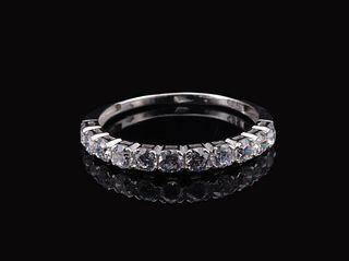 A white gold eternity ring set with a full circle of round brilliant-cut zircons in a channel setting.