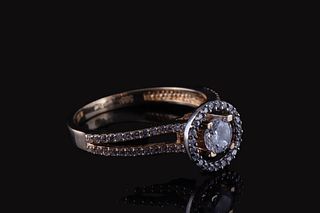 A rose gold halo ring with a central round Zircon and pavé-set Zircons on the band.