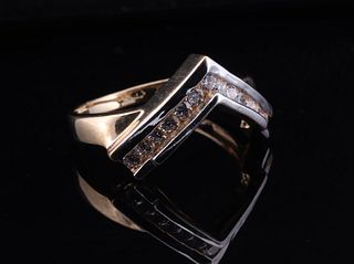 A modern, geometric design gold ring with a chevron pattern in a two-tone setting, 