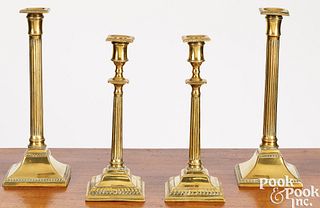 Two pair of George III brass candlesticks
