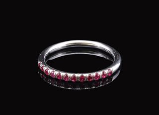 A white gold band ring channel-set with a continuous line of round-cut Rubies.
