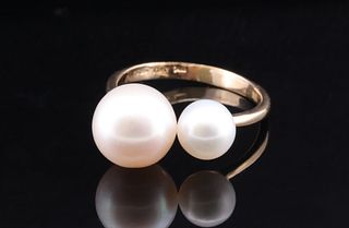A unique open-ended gold band design with Pearls